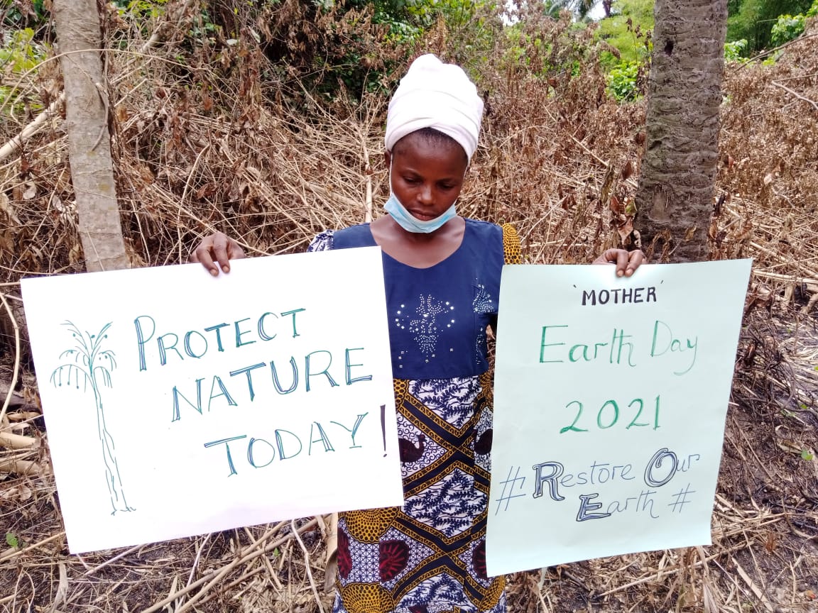 A herbal practitioner examining medicinal leaves in the forest